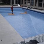 Pool liner being added to backyard pool