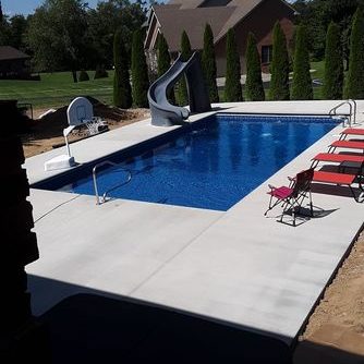rectangular pool in backyard with slide